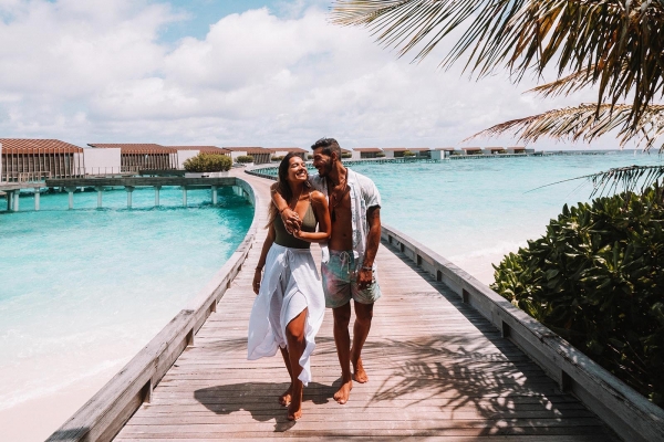 Couple Walking Water Villa Jetty